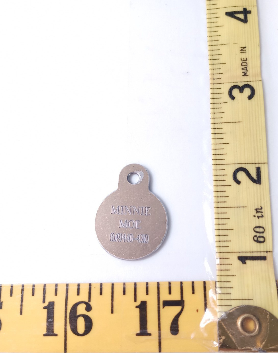 Vintage dog tag named Minnie Moe silver colored